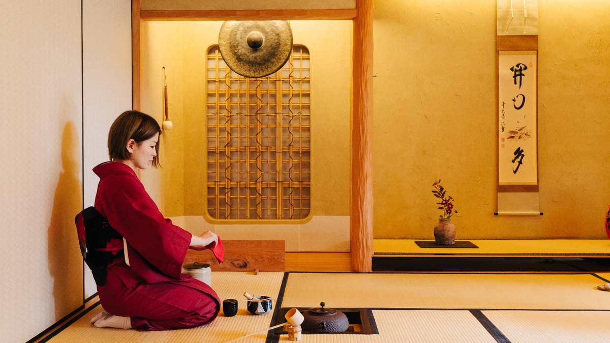 A traditional Japanese tea house beside a quiet garden