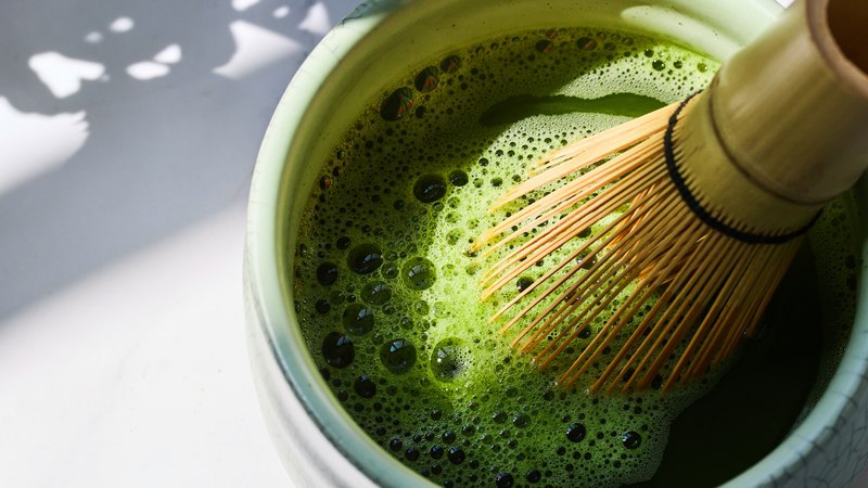 Matcha being scooped with a bamboo chashaku