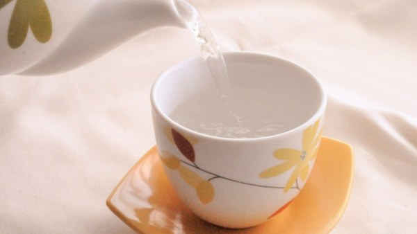 Hot water poured into a cup to cool it before brewing