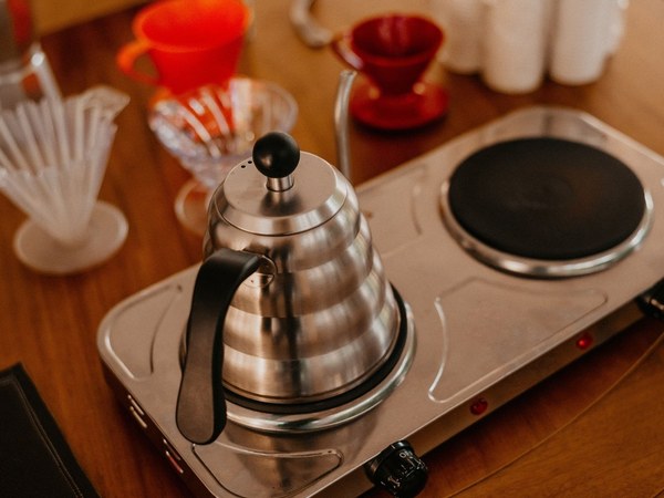 A gooseneck kettle on a heat source