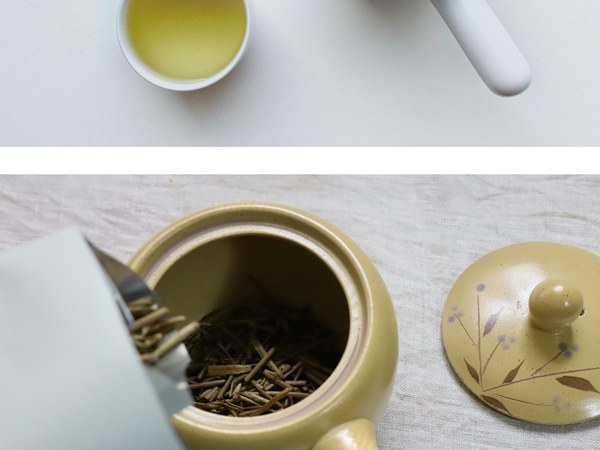 A kyusu with its lid off and tea leaves inside