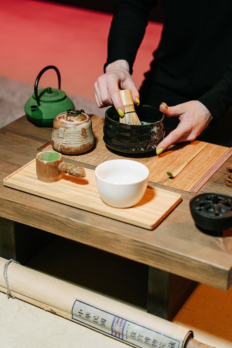 Matcha being whisked into a froth in a bowl