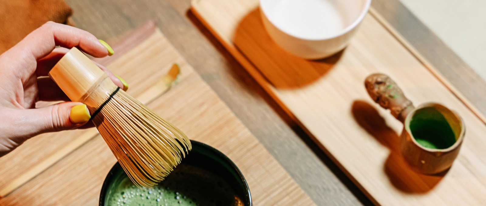 Whisking a bowl of matcha with traditional Japanese tea tools