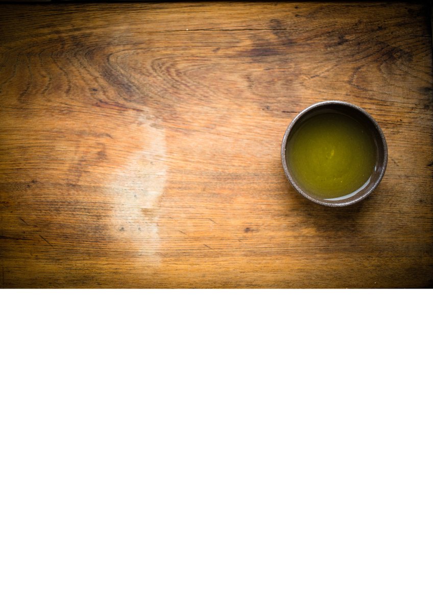 A handmade Bizen ware teacup, unglazed reddish-brown clay