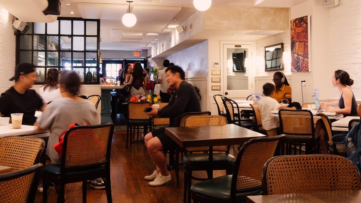 The dining room in the morning, full of people with coffee and matcha